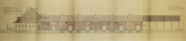 Ein detaillierter Grundriss eines mehrfenstrigen Gebäudes auf einem Blatt Papier mit begleitendem Text, der mutmaßlich ein Bauplan für eine neue Schule ist.